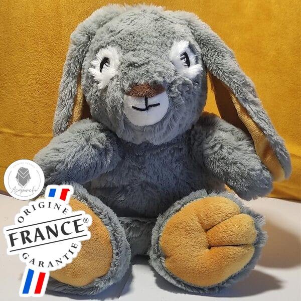 Bouillotte peluche lapin gris chauffante, remplie de blé et de lavande, distribuée par Acaponcho, fabriquée en France pour une chaleur douce et apaisante.