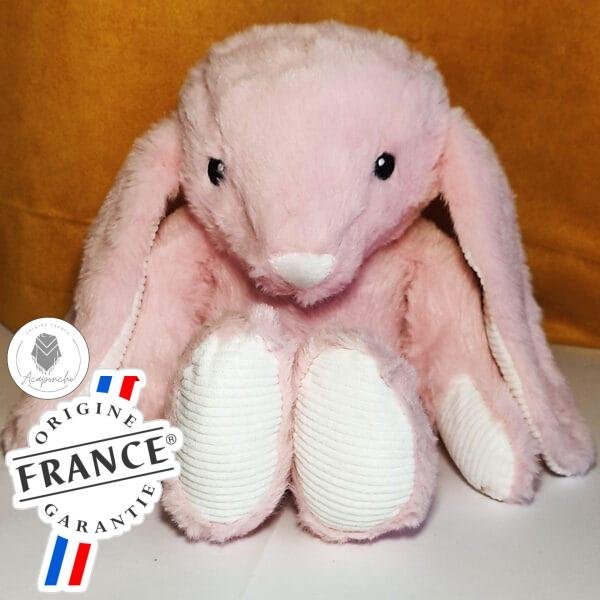 Bouillotte peluche lapin rose chauffante, remplie de blé et de lavande, distribuée par Acaponcho, fabriquée en France pour une chaleur douce et apaisante.