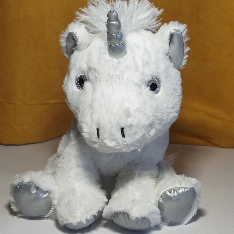 Bouillotte peluche licorne blanche et gris argenté chauffante, remplie de blé et de lavande, distribuée par Acaponcho, fabriquée en France pour une chaleur douce et apaisante.