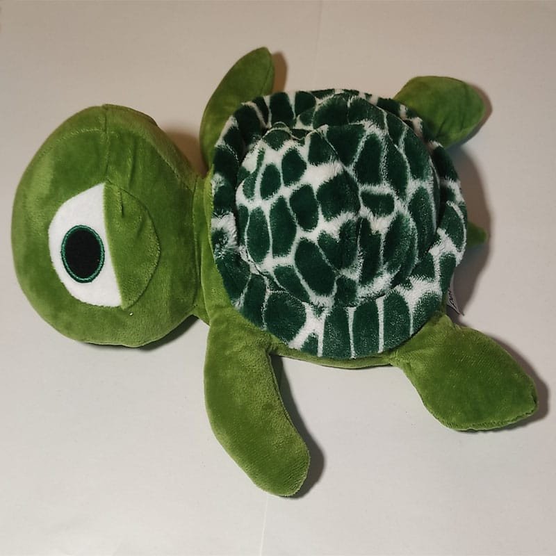 Bouillotte peluche tortue verte chauffante, remplie de blé et de lavande, distribuée par Acaponcho, fabriquée en France pour une chaleur douce et naturelle.