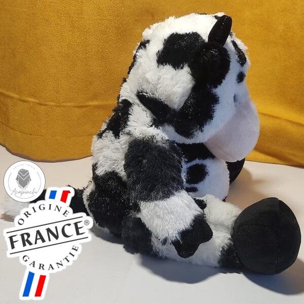 Bouillotte peluche vache chauffante, vendue par Acaponcho, fabriquée en France pour offrir une chaleur douce et réconfortante.